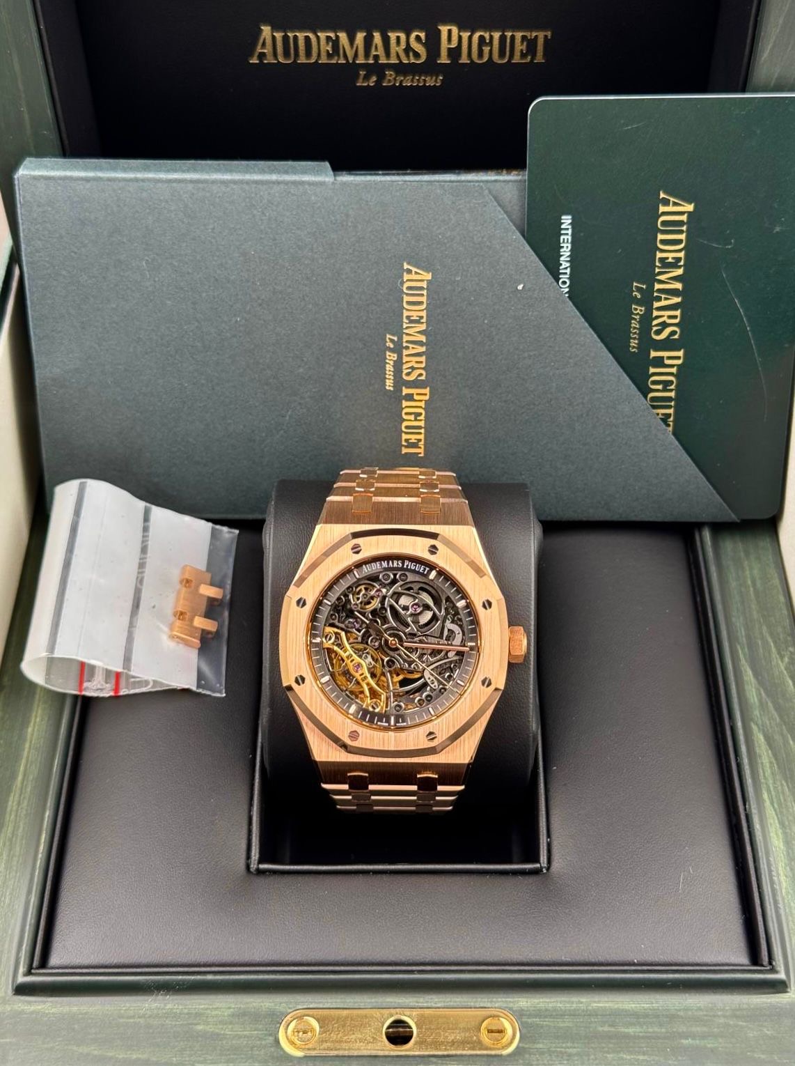 Rose gold octagonal sports watch with an open-worked tourbillon dial in its presentation box